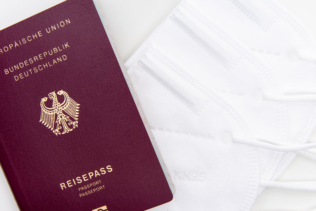 services-03 Close-up of a German passport and KN95 masks symbolizing travel during the pandemic.
